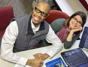 minnesota employment center pair smiling at desk